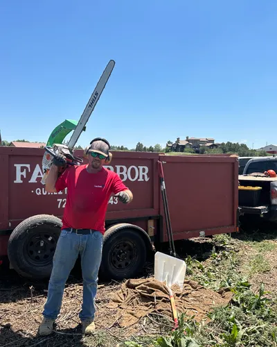 Jeff Farr with chainsaw by the Farr Arbor trailer